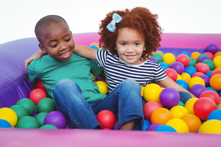 Family entertainment center insurance – kids playing in a colorful ball pit.
